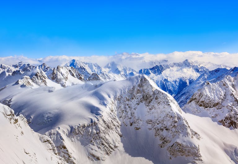 Breathtaking view of the snow-covered peaks in the Swiss Alps under a clear blue sky.