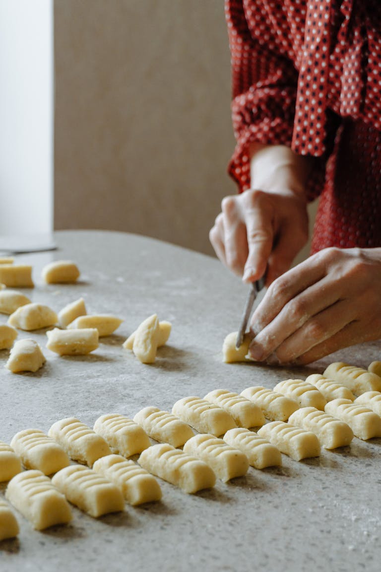 Close-up of homemade gnocchi being prepared on a table in a Milan, Italy kitchen.