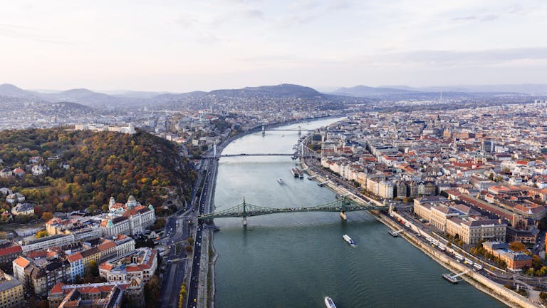 Stunning aerial view of Budapest, showcasing the Danube River, bridges, and cityscape.